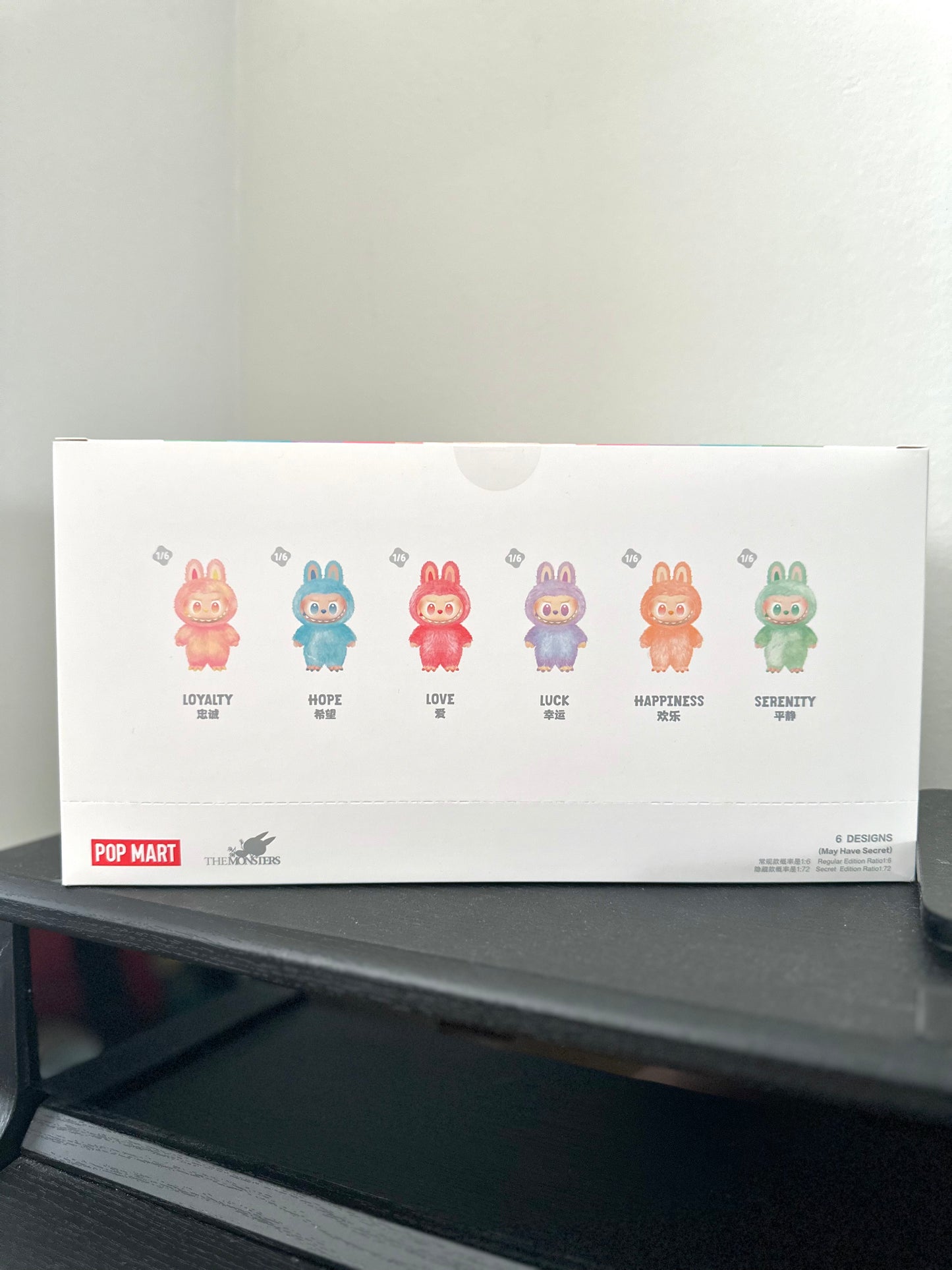 Box with cartoon characters and text on a gray surface