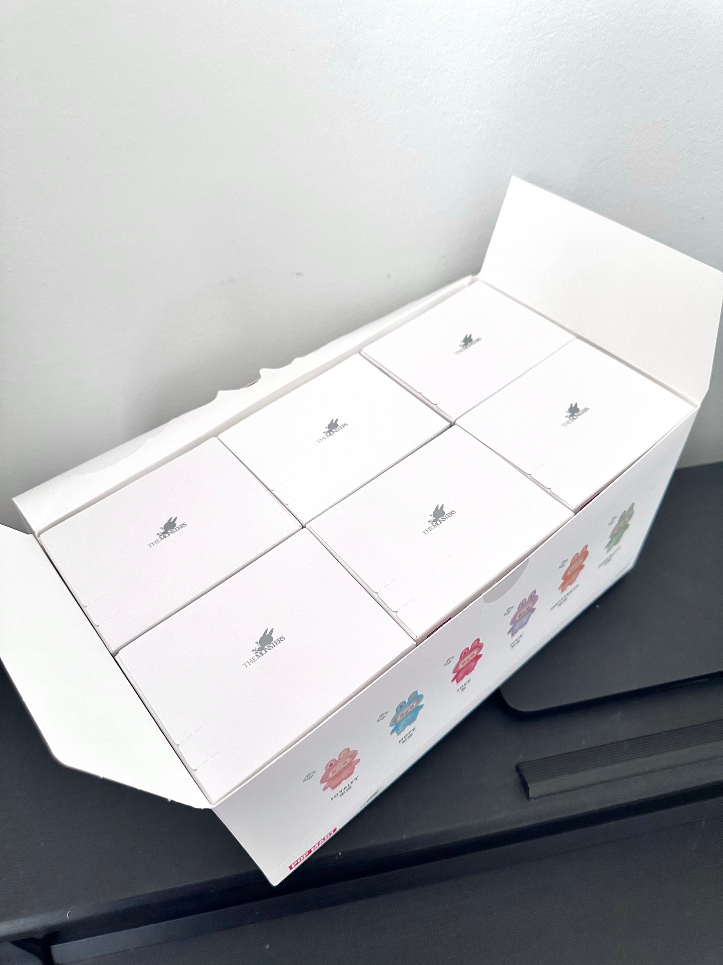 White box with floral designs on a gray surface