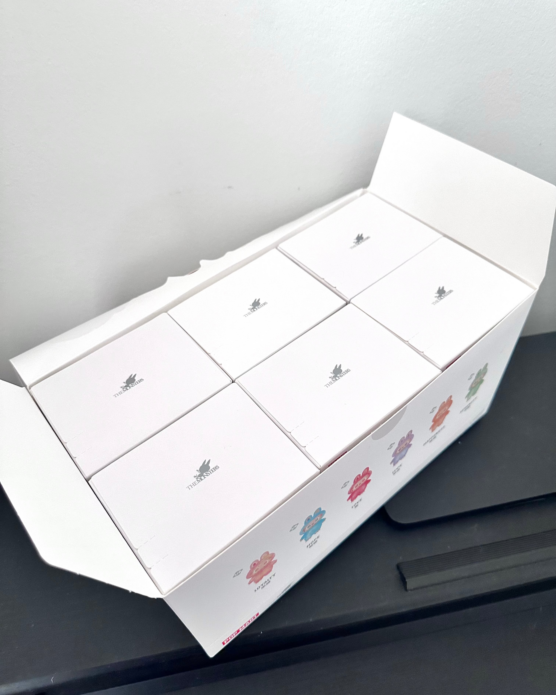White box with floral designs on a gray surface