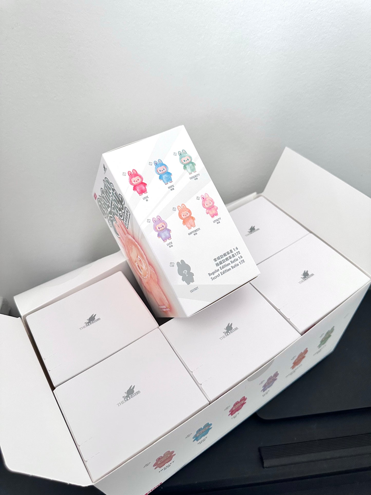 White box with colorful product packaging on a gray background