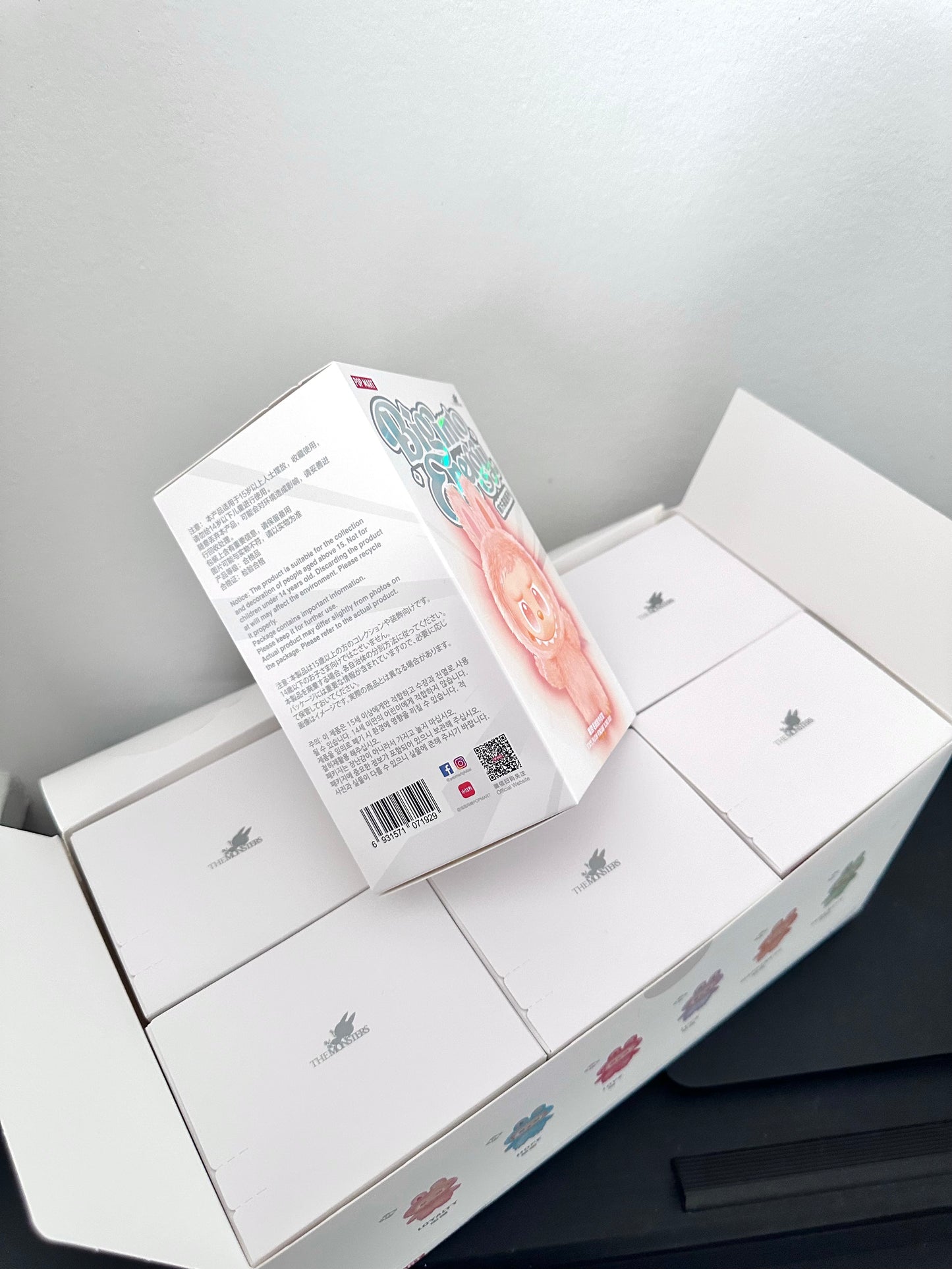 Product packaging with text and a barcode on a gray background