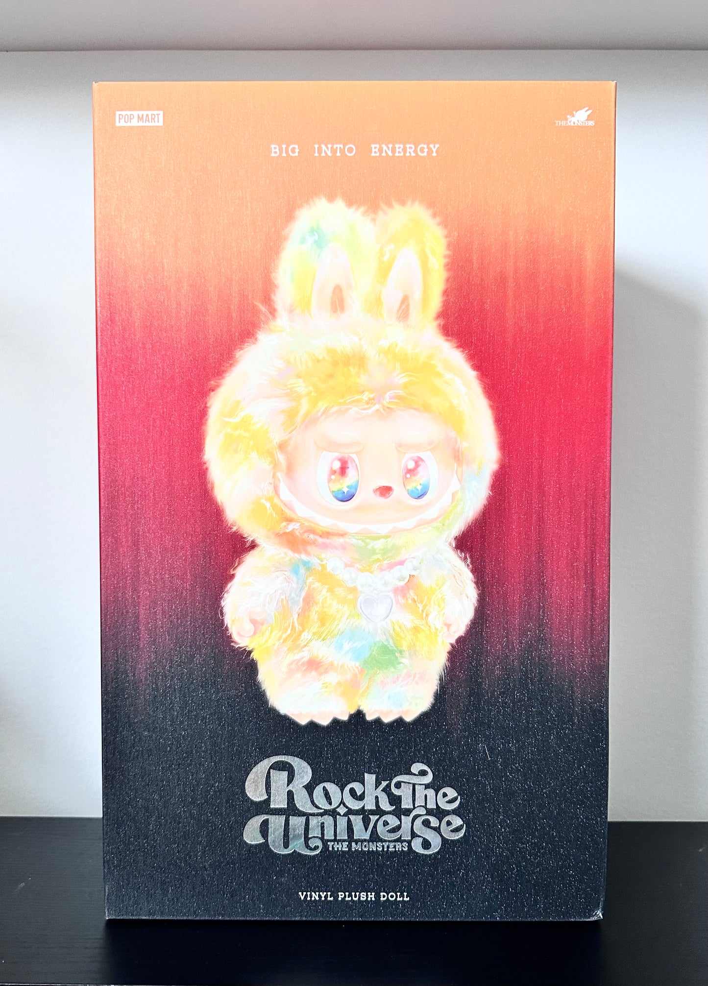 Plush doll packaging with gradient background and text