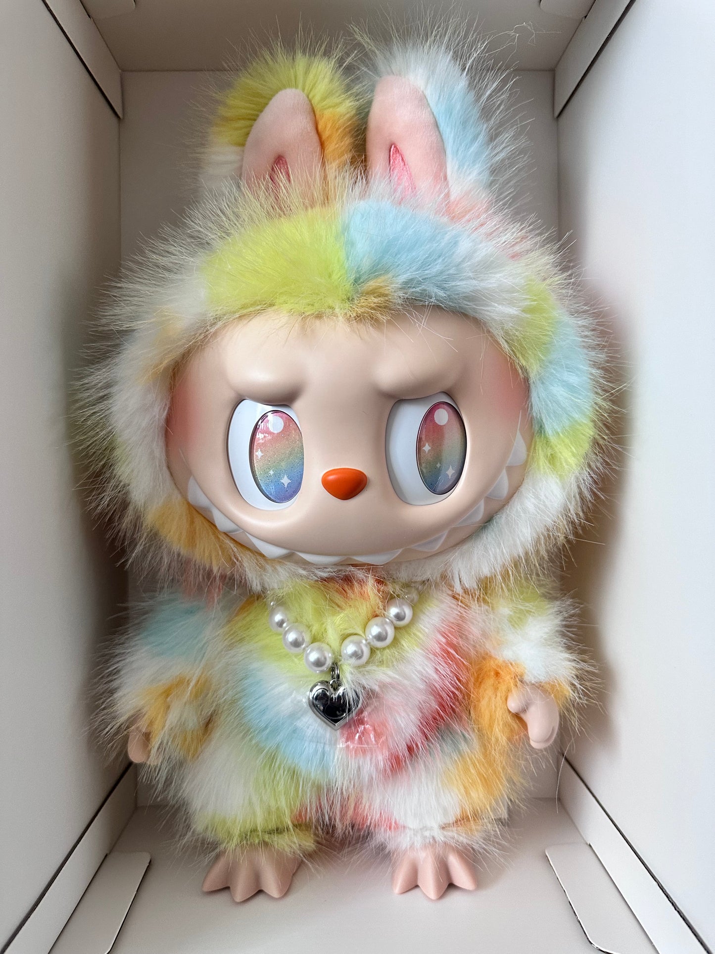 Toy monkey with colorful fur and electronic components on a white background