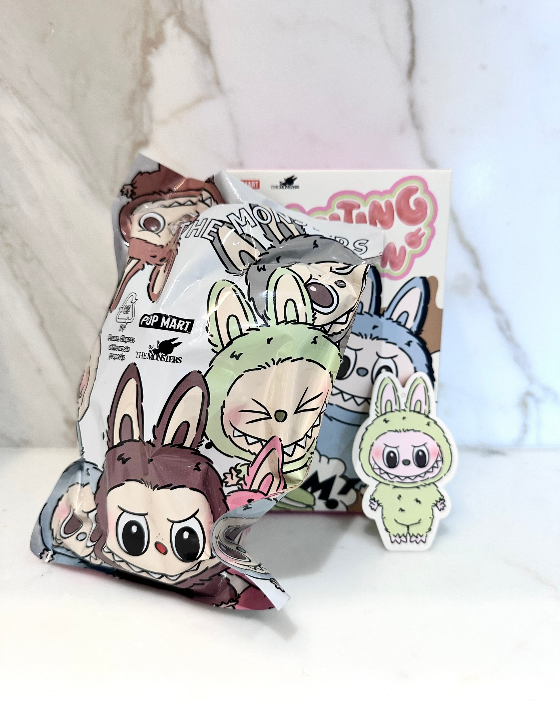 Cartoon character plushies and packaging on a white background