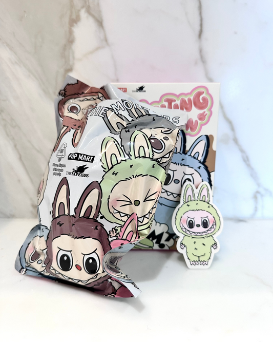 Cartoon character plushies and packaging on a white background