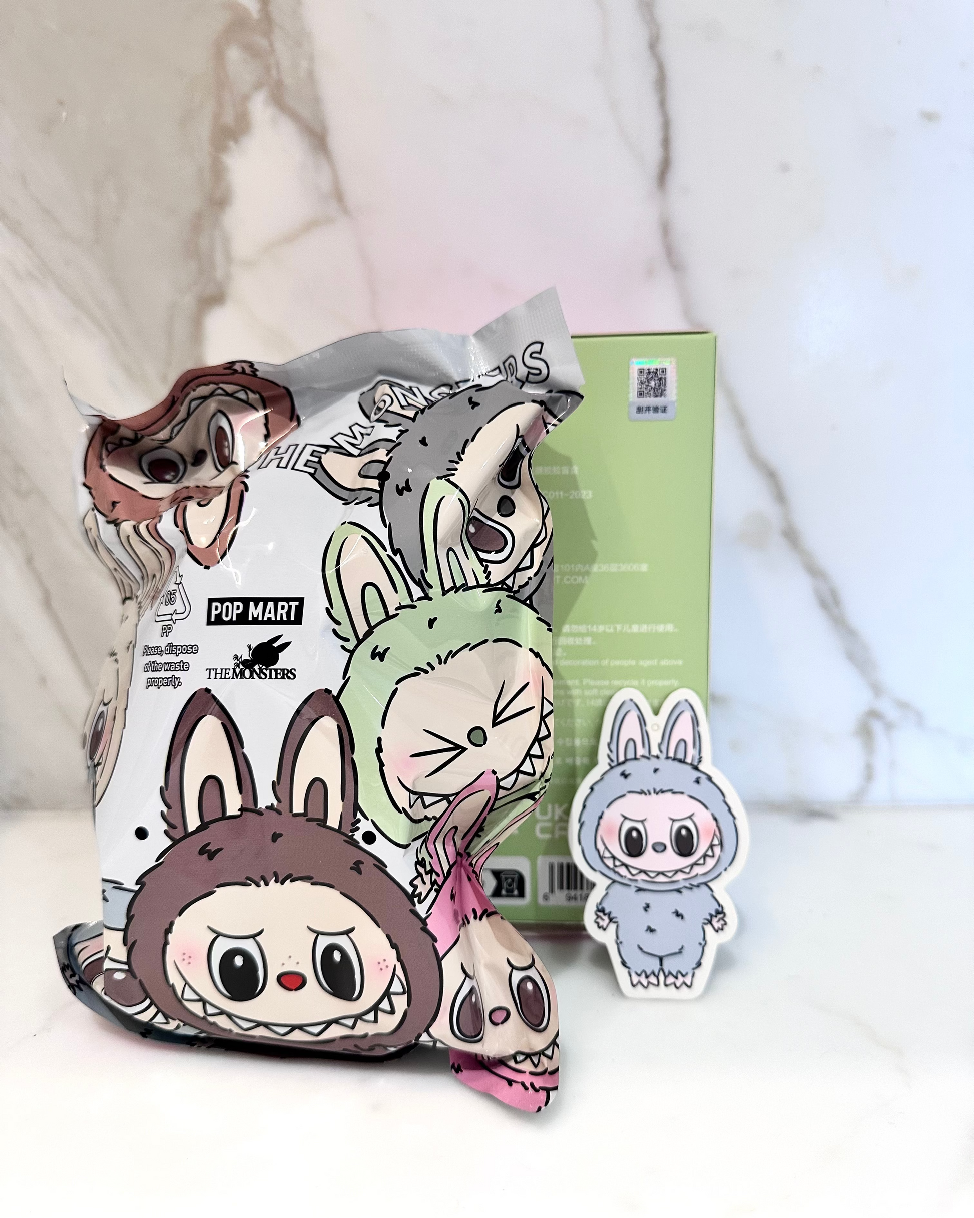 Cartoon character plush toys with packaging on a soft white background