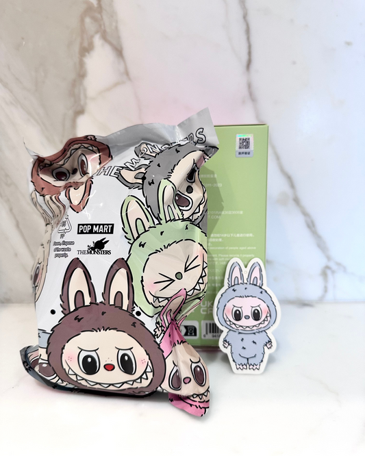 Cartoon character plush toys with packaging on a soft white background
