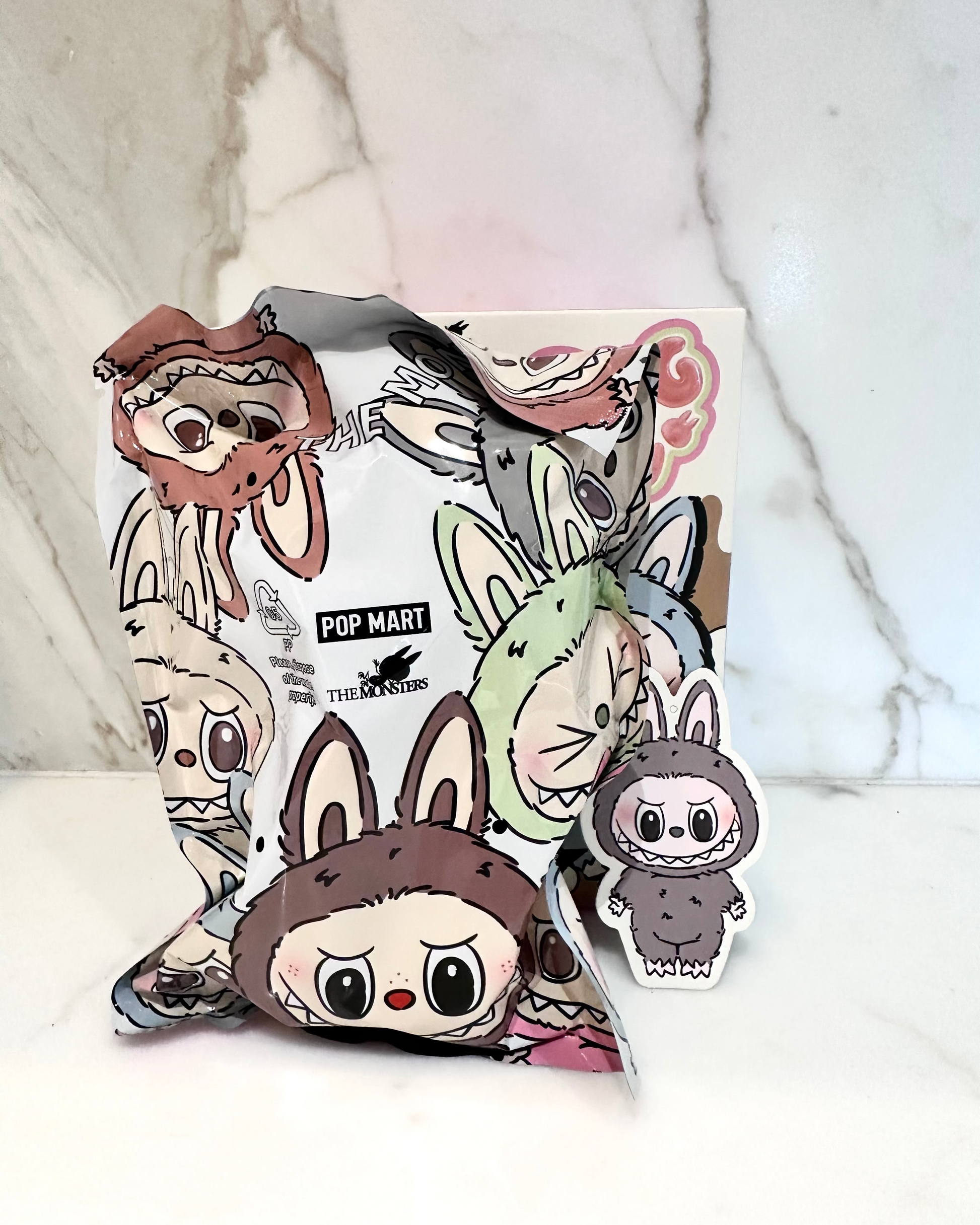 Cartoon character plush toy packaging with 'Pop Mart' branding on a white background