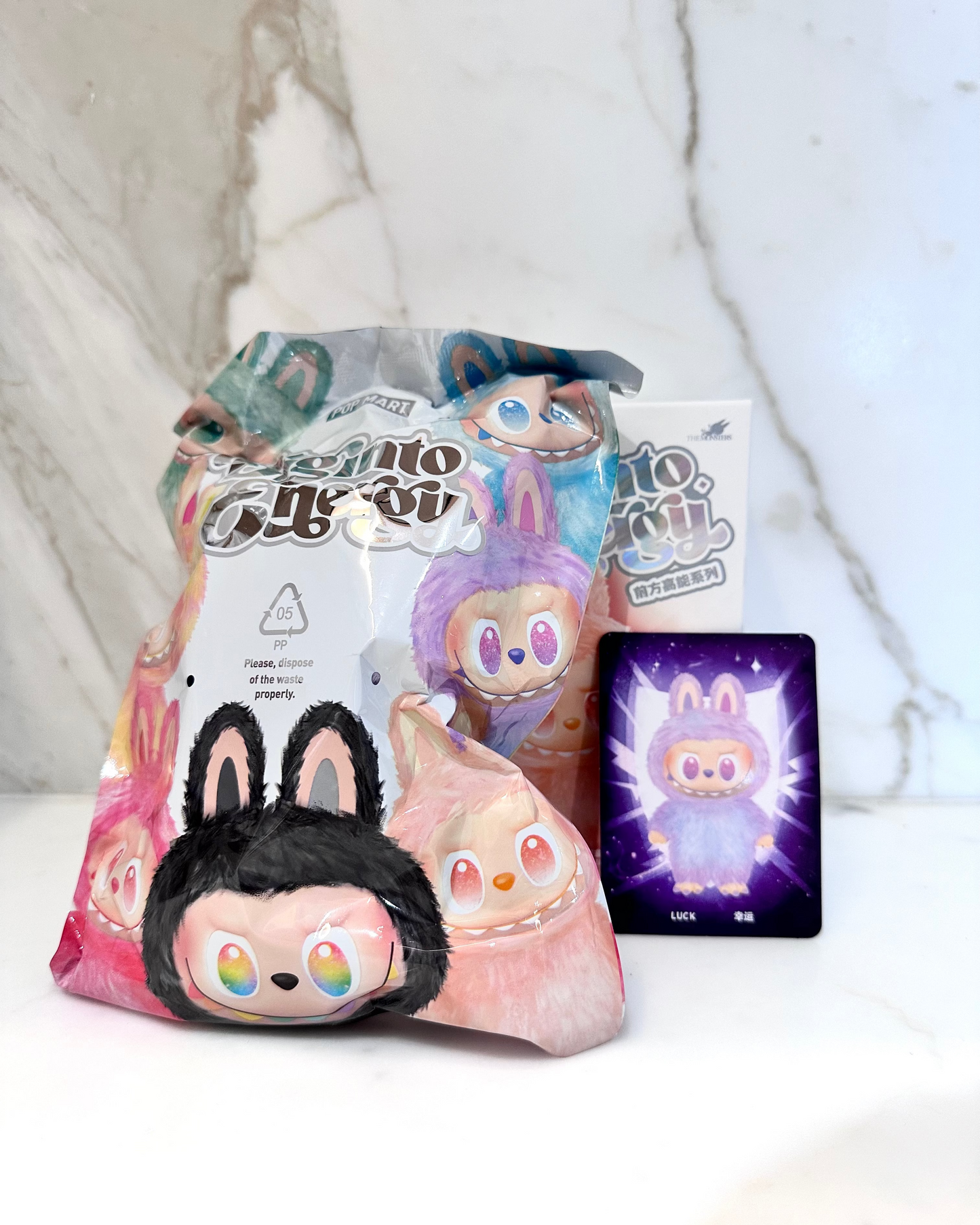 Cartoon character plush toy with packaging and digital card on a white background