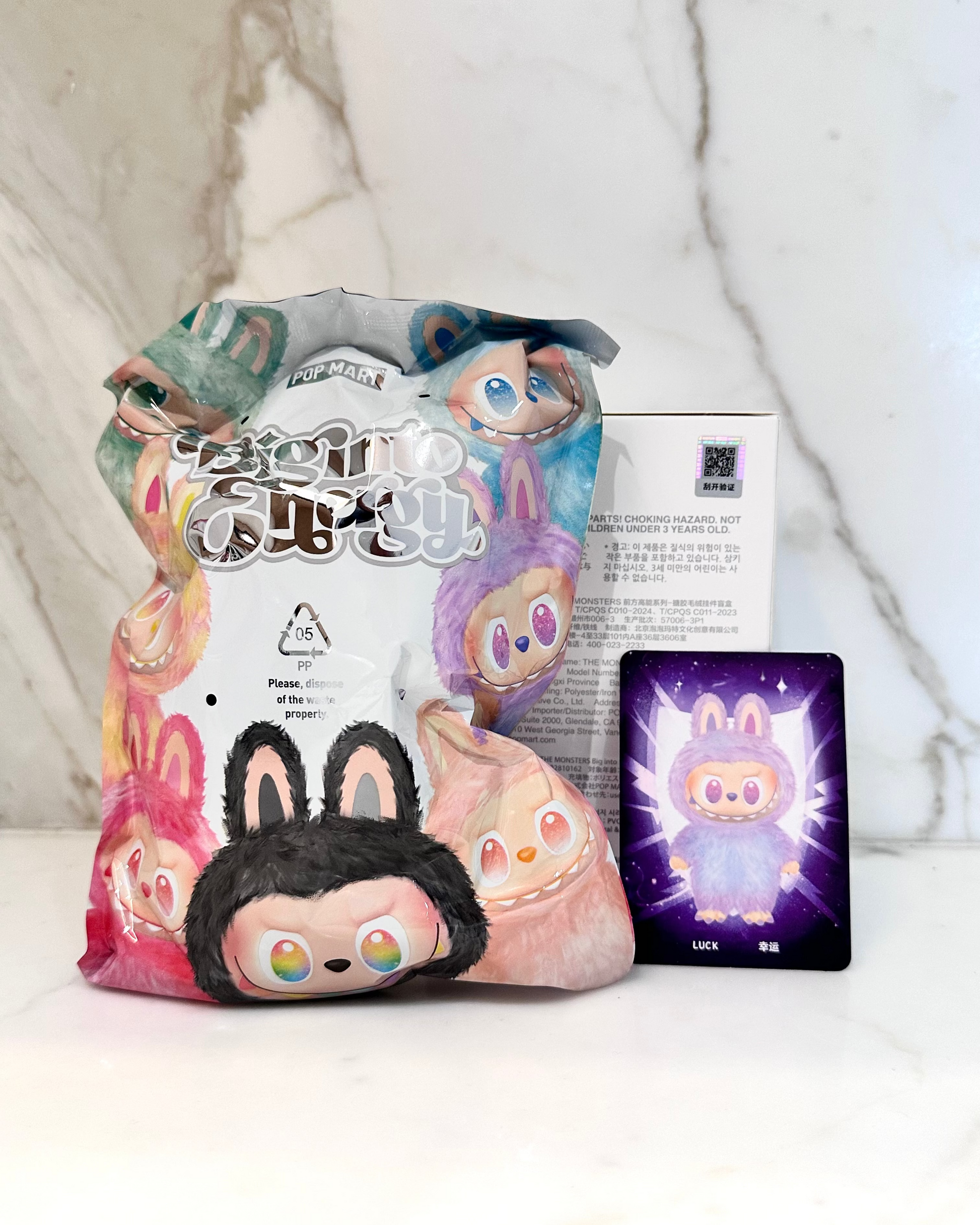 Plush toy with packaging and character card on a light background