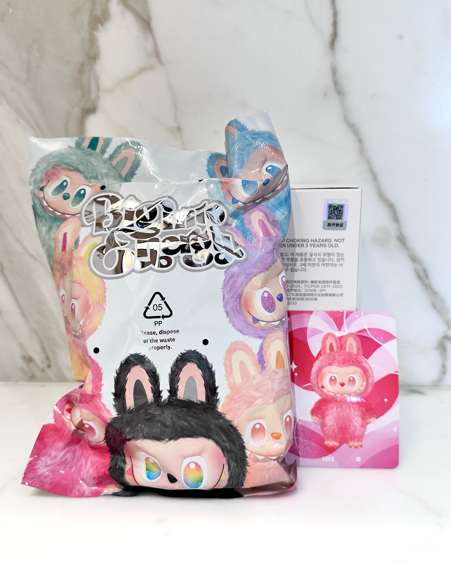 Plush toy with colorful packaging on a light background