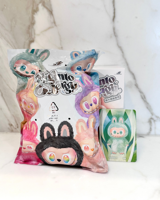 Collection of colorful plush toys with 'Into The Kitty' branding on a white background