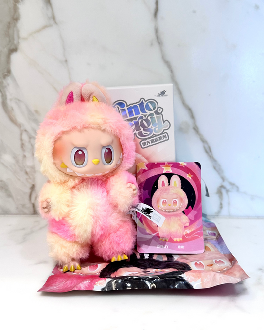 Pink plush toy with packaging on a light background