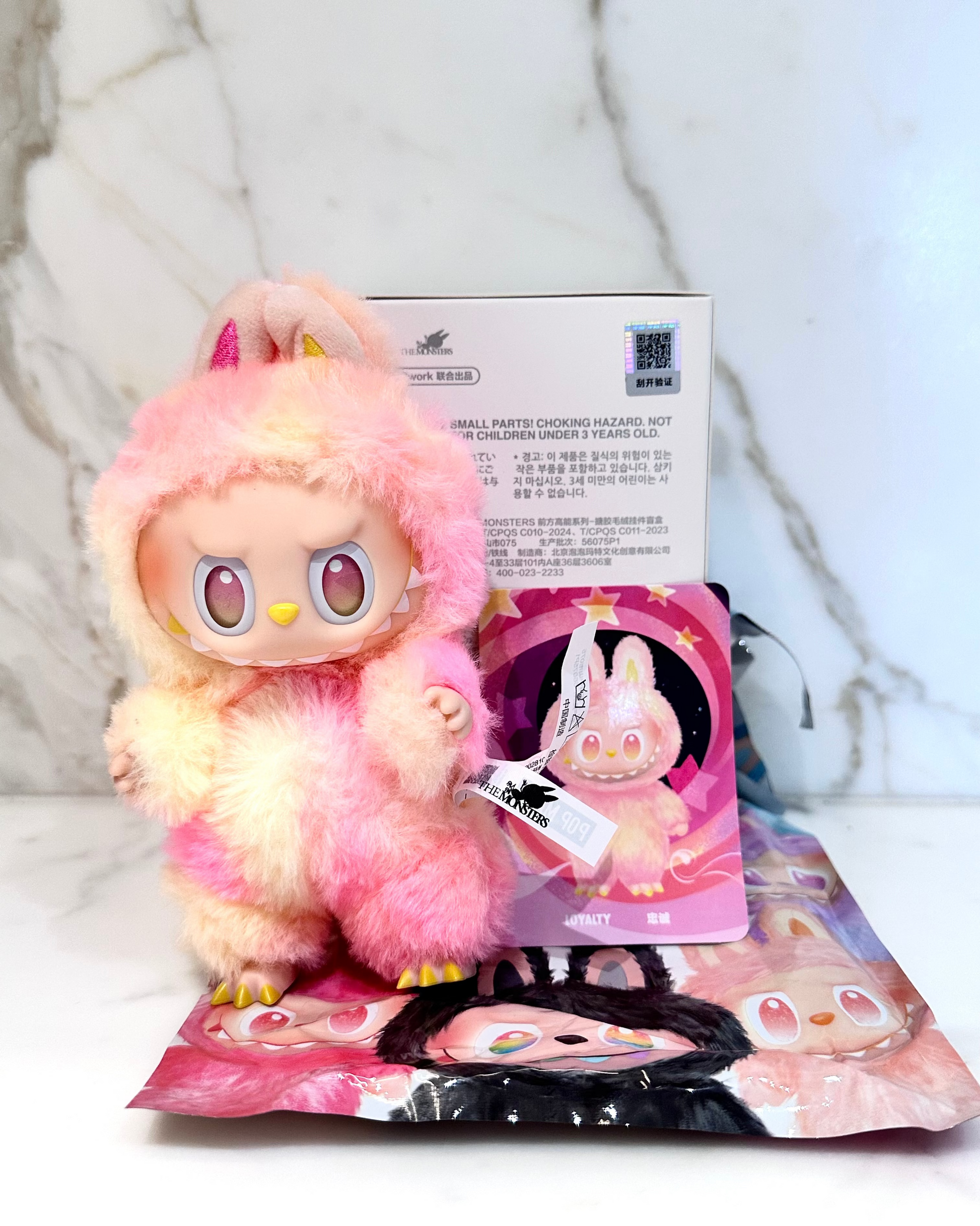 Plush toy with packaging on a light background