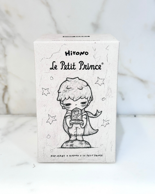 Card featuring a stylized illustration of 'Le Petit Prince' on a white background with star designs.