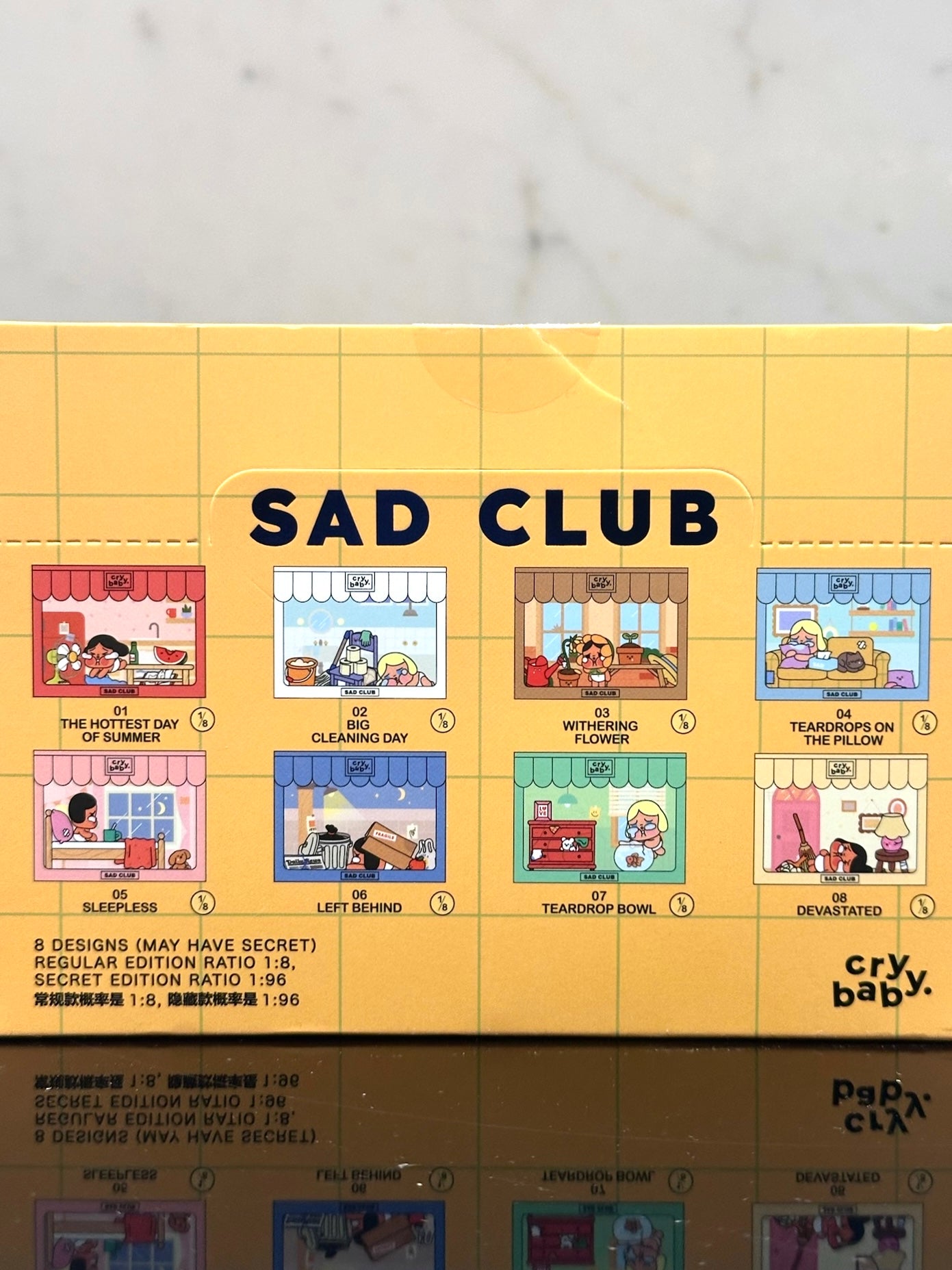 Product packaging for 'Sad Club' with cartoon illustrations on a yellow background