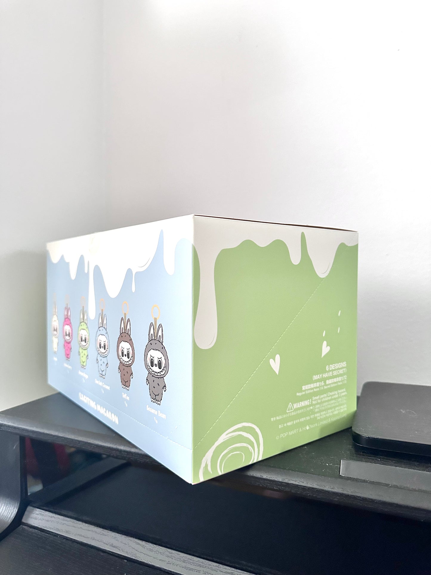 Product packaging box with cartoon characters on a desk