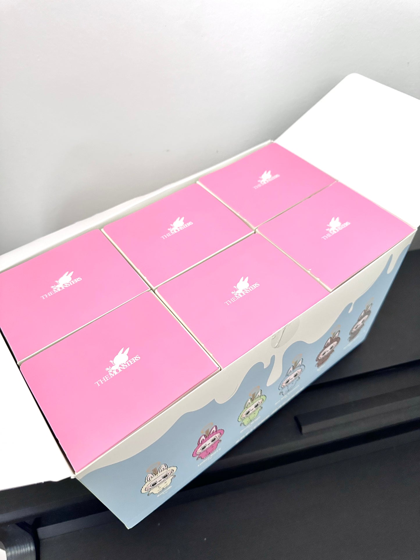 Pink packaging with white labels on a gray surface