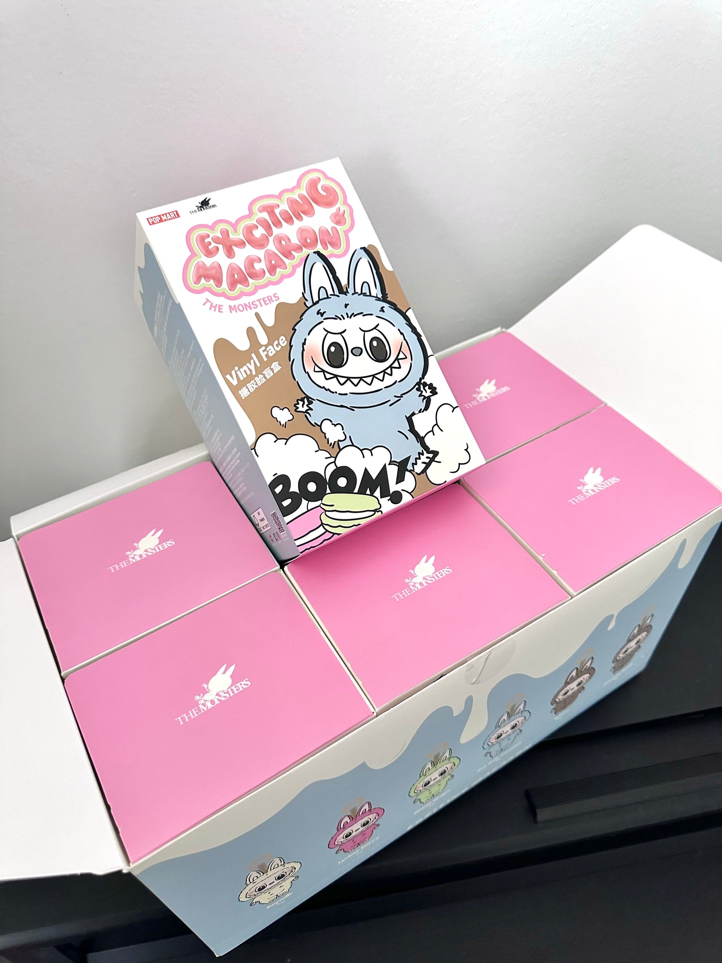 Pink box with cartoon character on a gray background