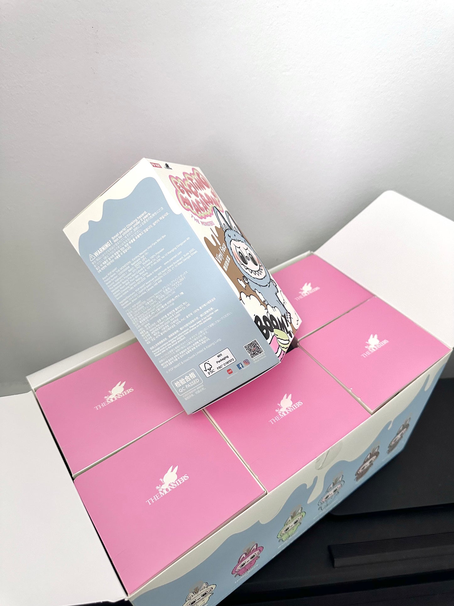 Unboxed pink and gray box with floral design on a white background