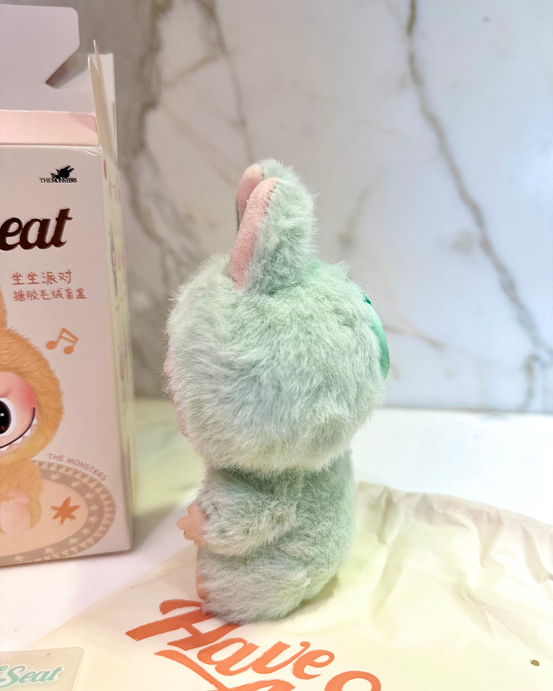 Plush toy resembling a rabbit with a blurred background