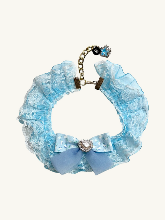 Blue lace bracelet with decorative elements on a white background
