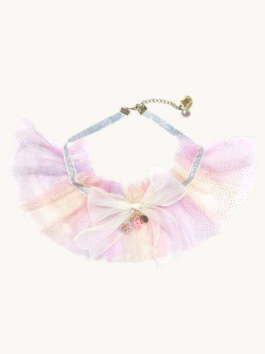 Pastel-colored bow with a chain on a white background