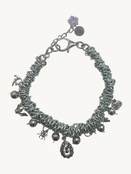 Silver necklace with charms on a white background