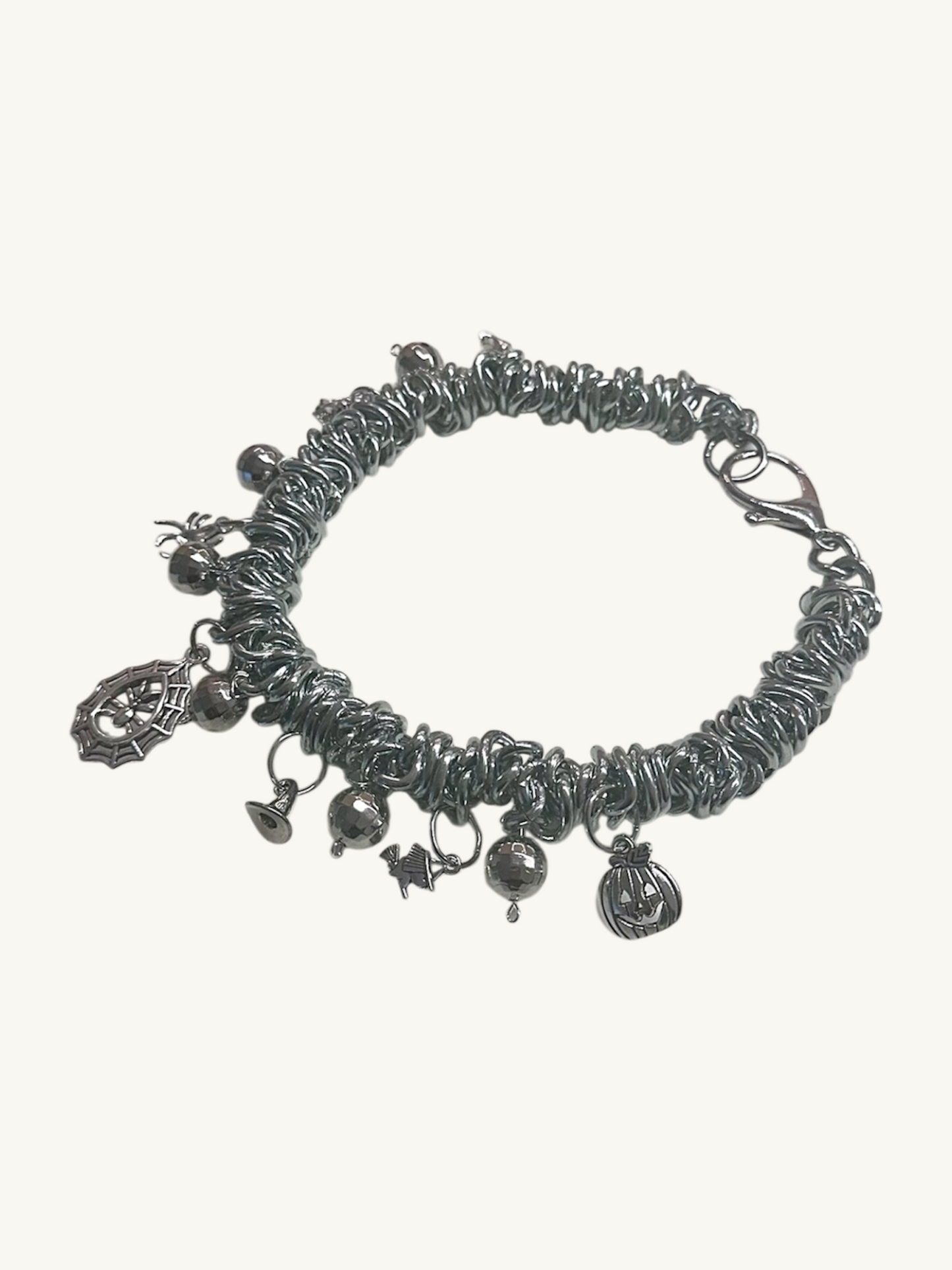 Silver bracelet with charms on a white background