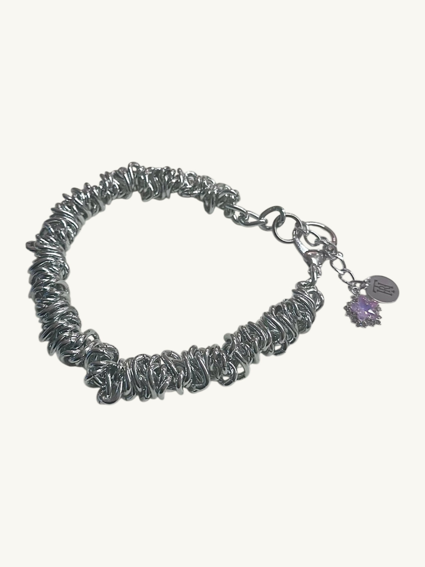Silver bracelet with a charm on a white background