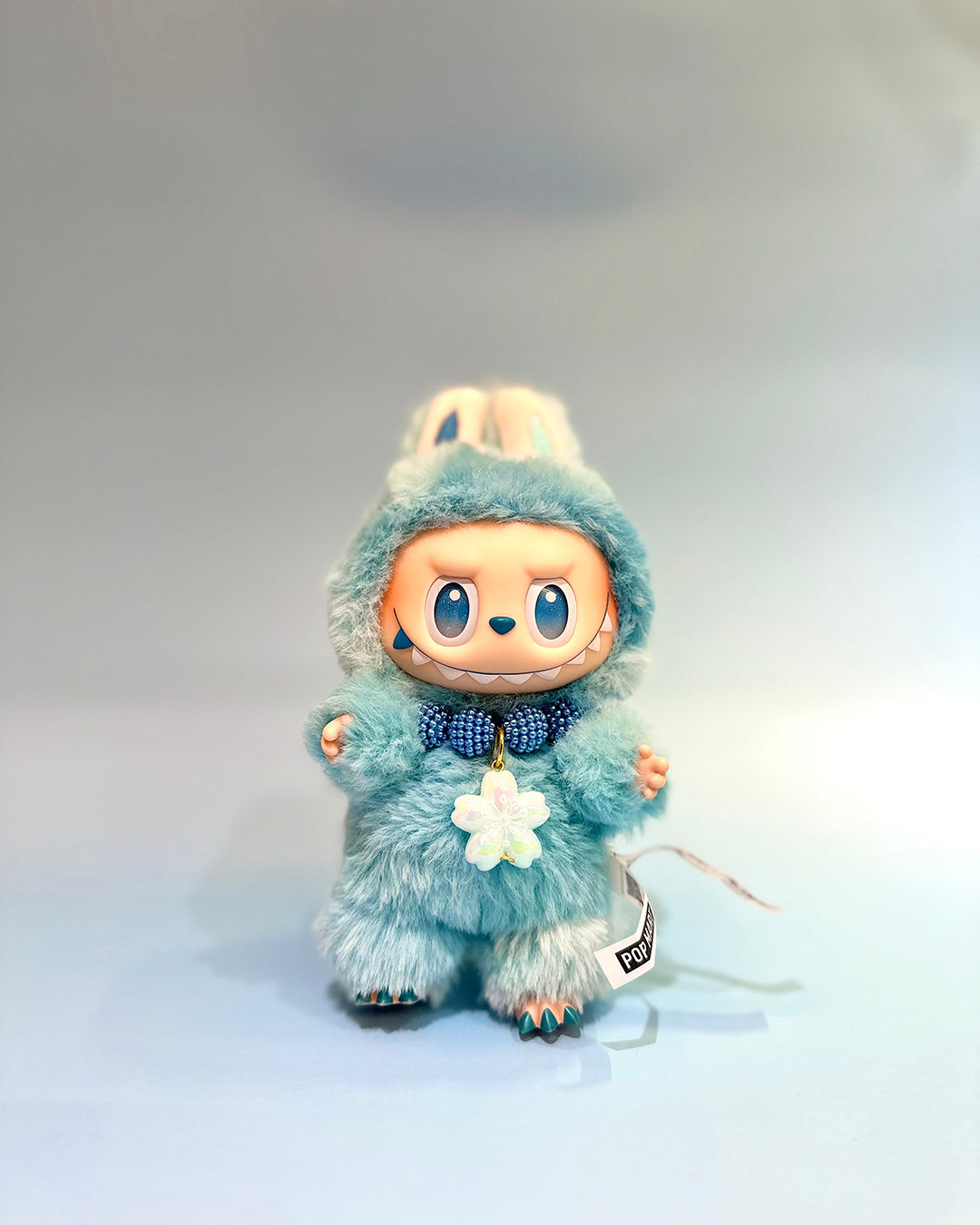 Toy figure in a blue outfit with a white background