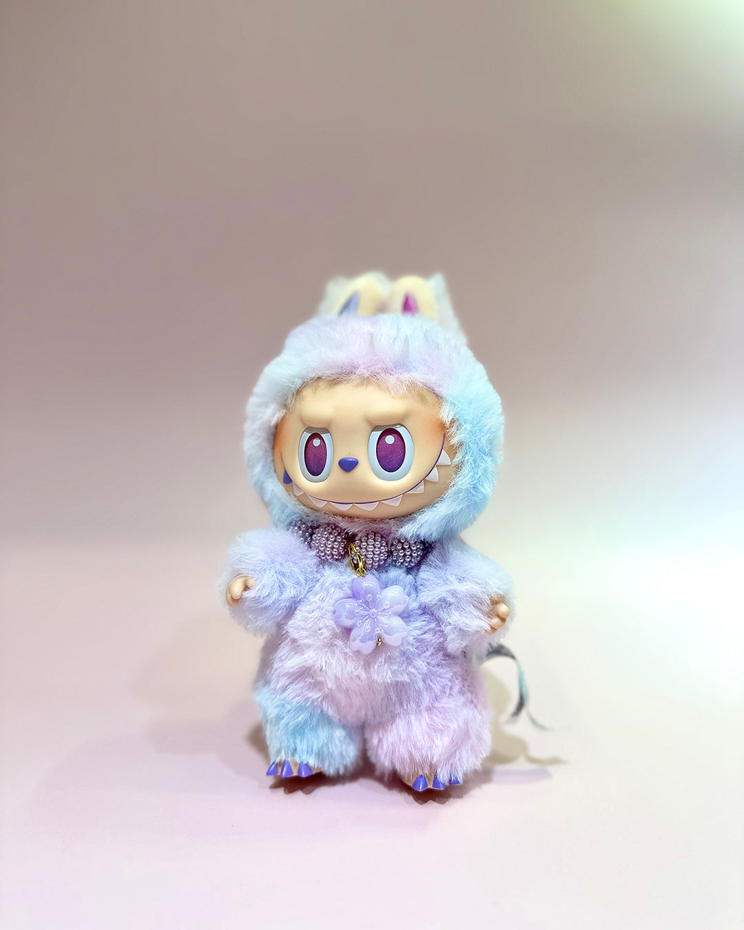 Plush toy with a blue and white fur coat on a light gray background
