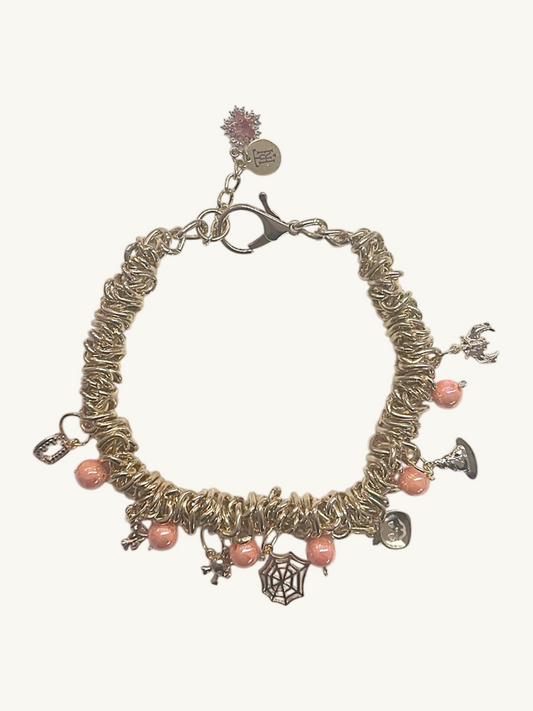 Bracelet with pink beads and charms on a white background