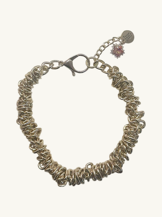 Silver bracelet with a clasp on a white background