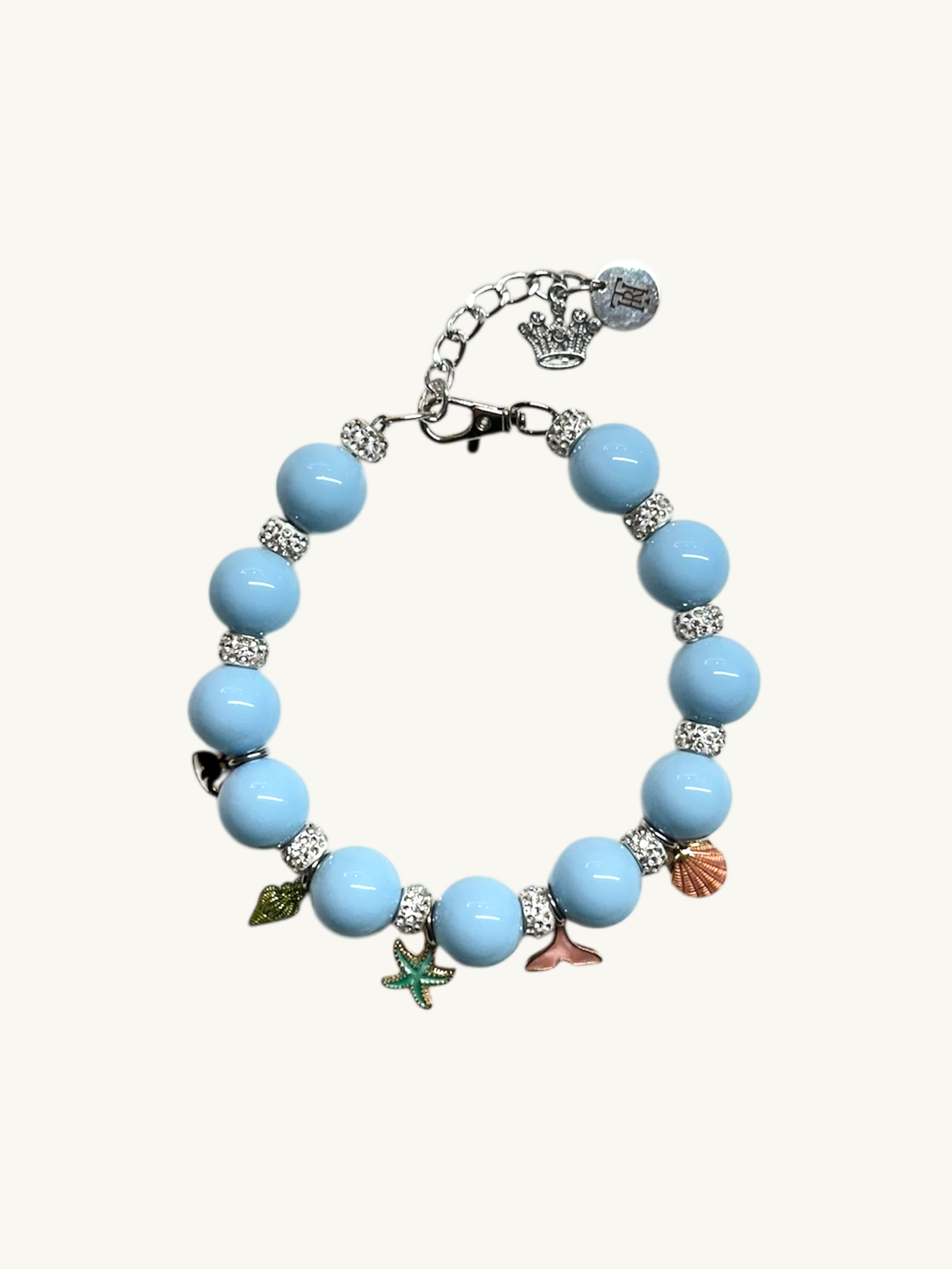Bracelet with blue beads and various charms on a white background