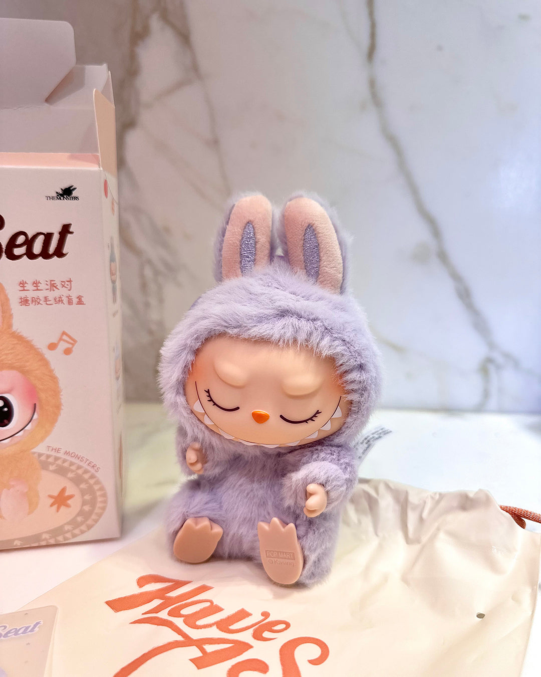 Plush toy in a purple outfit with a blurred background