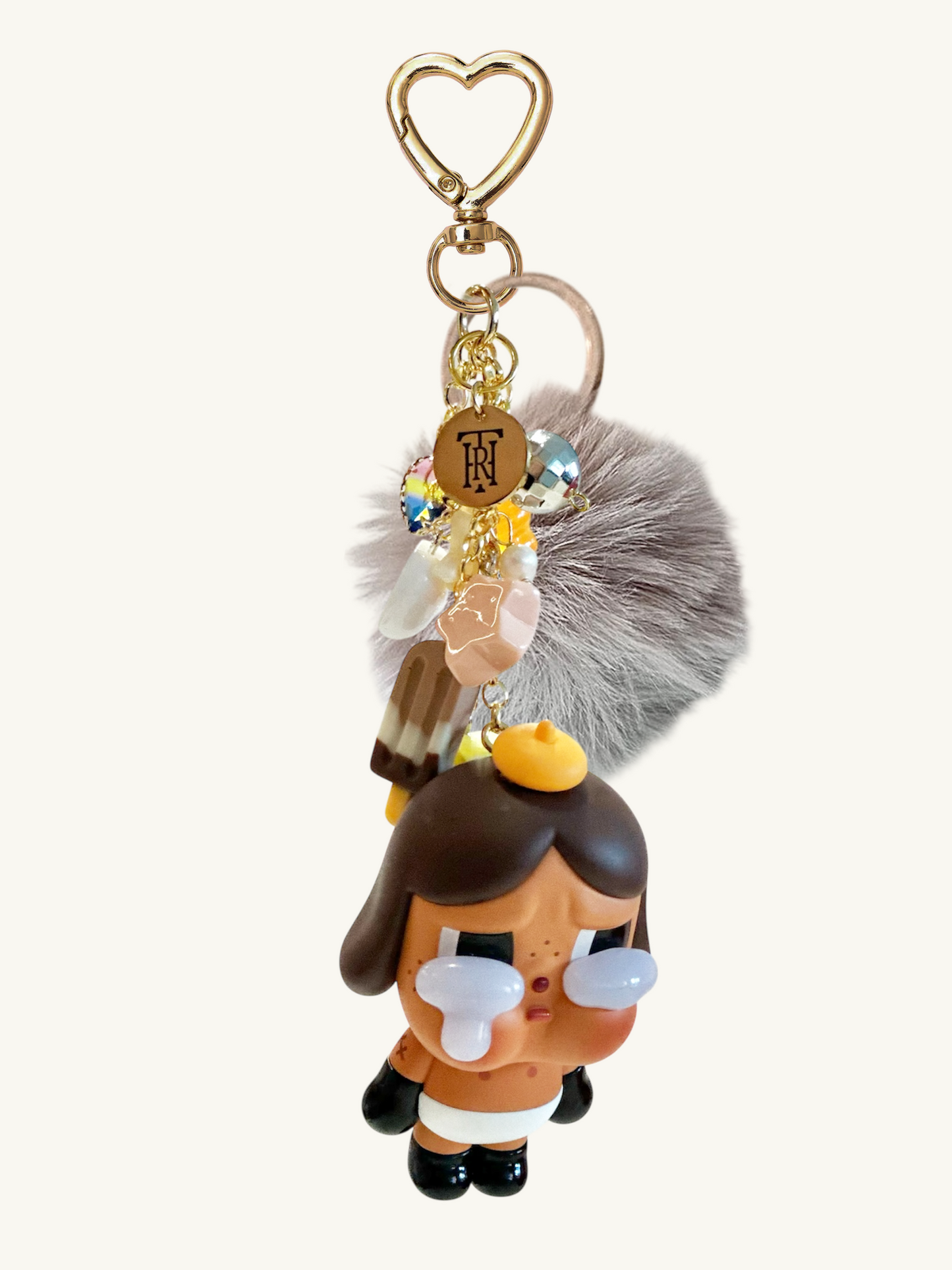Keychain with a cartoon character and fluffy accessory on a white background