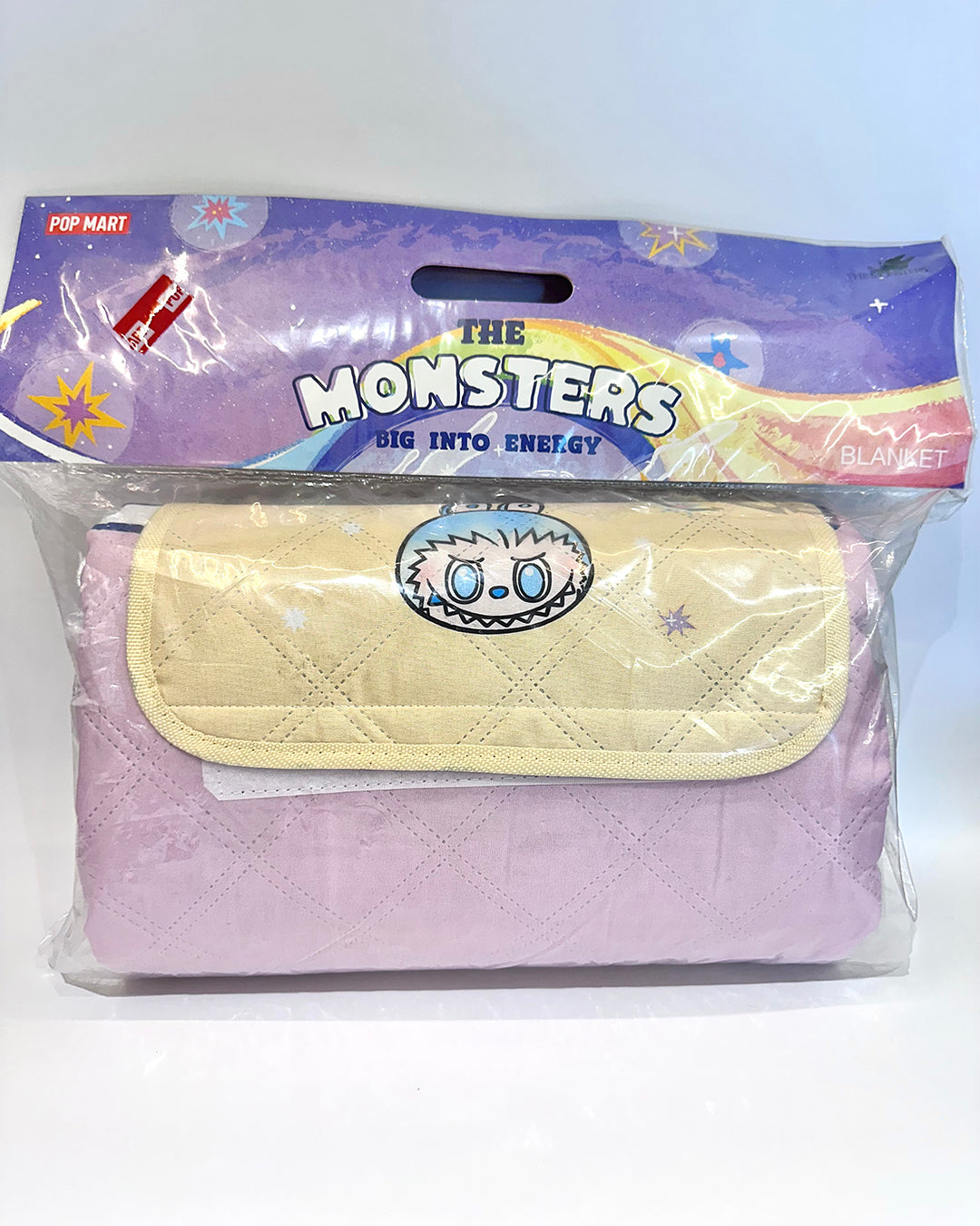 Packaged blanket with 'The Monsters' design on a white background