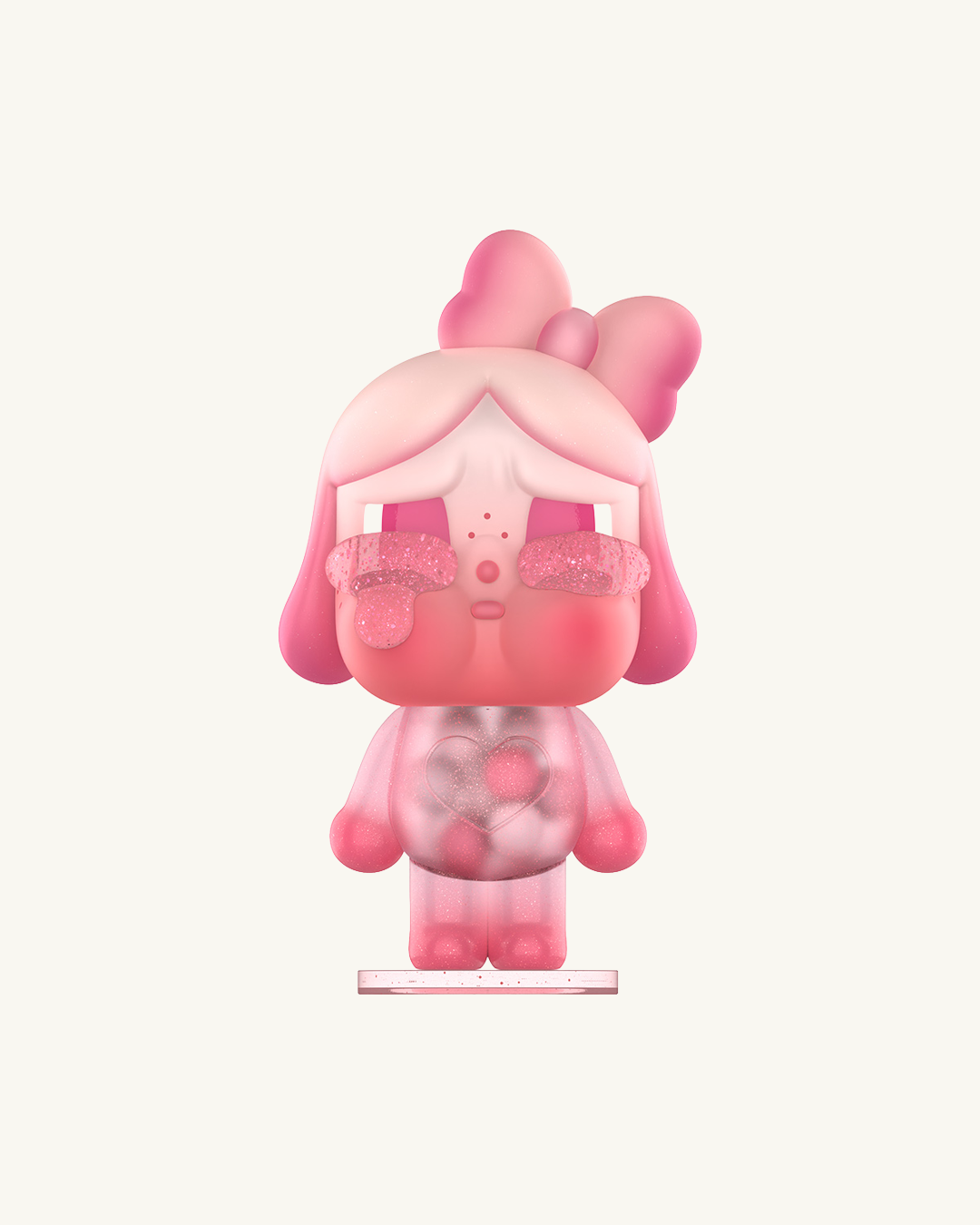 Pink cartoon character figurine with a bow on a white background