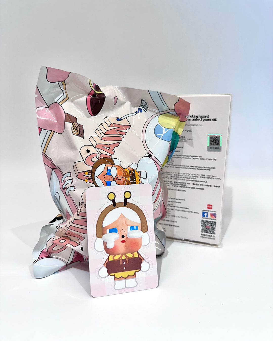 Colorful cartoon character pillow with packaging on a white background