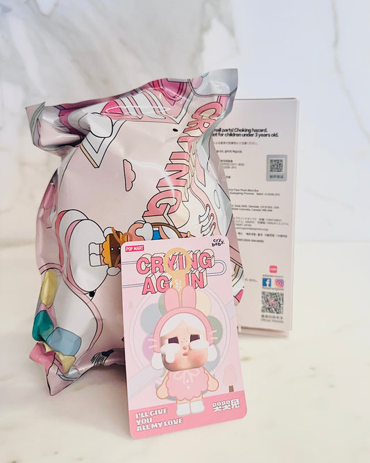 Crying Again plush toy packaging with colorful design on a white background