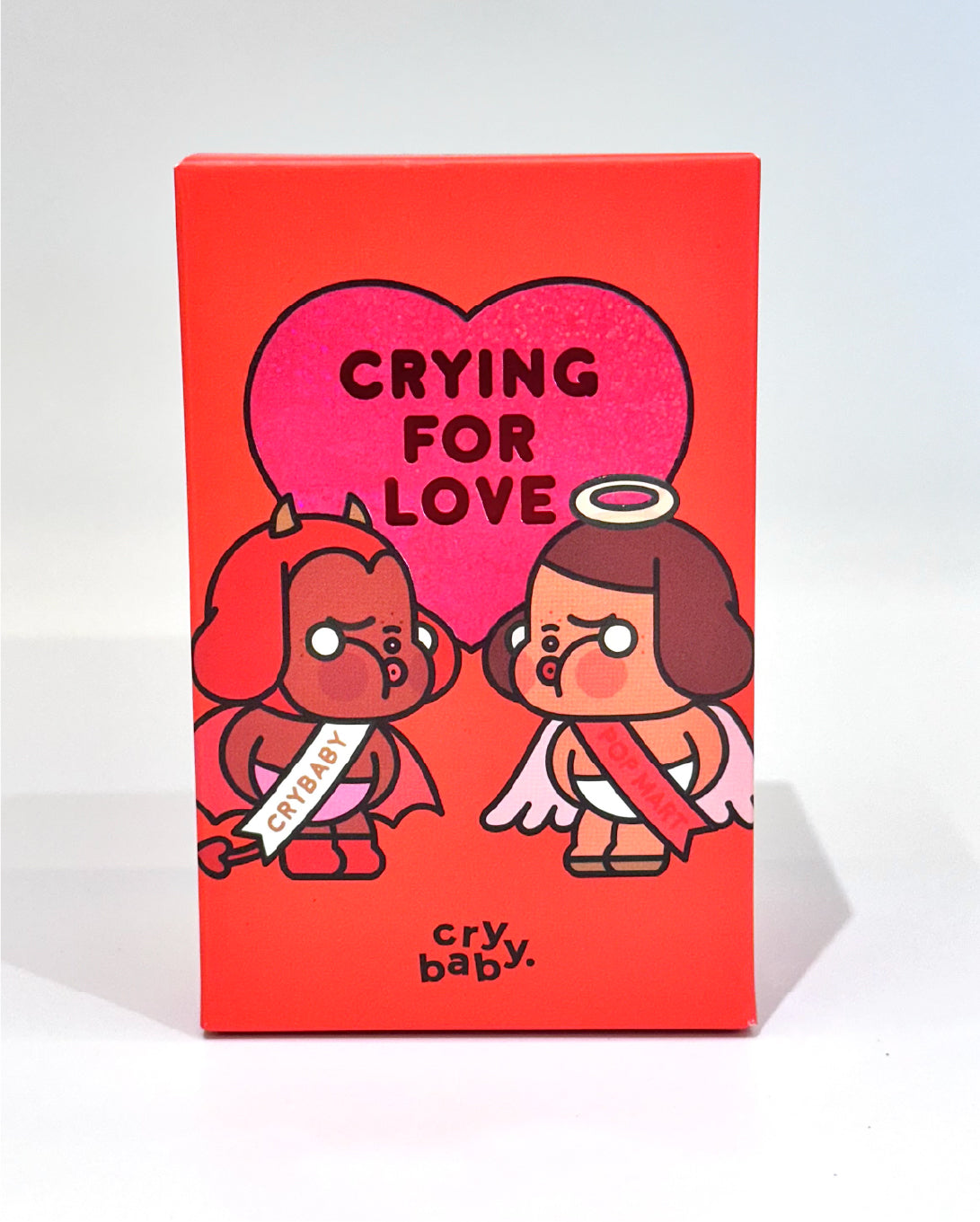 Product packaging with cartoon characters and text 'Crying for Love' on a red background