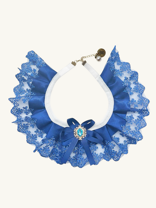 Blue lace collar necklace with a white center and decorative element on a white background