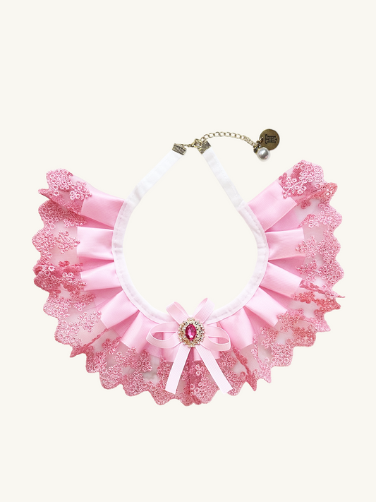 Pink lace collar with a decorative bow on a white background