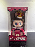 Toy figure in a box with a crown and red outfit, brand 'Pop Mart' visible