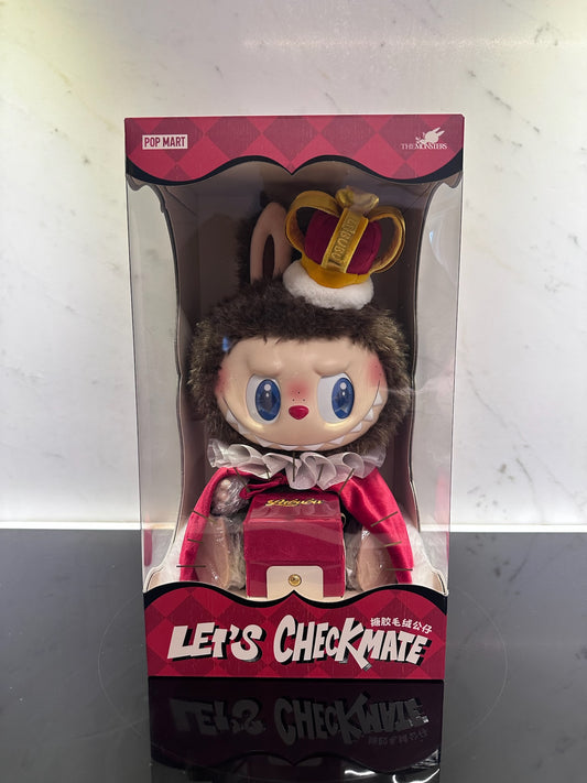 Toy figure in a box with a crown and red outfit, brand 'Pop Mart' visible