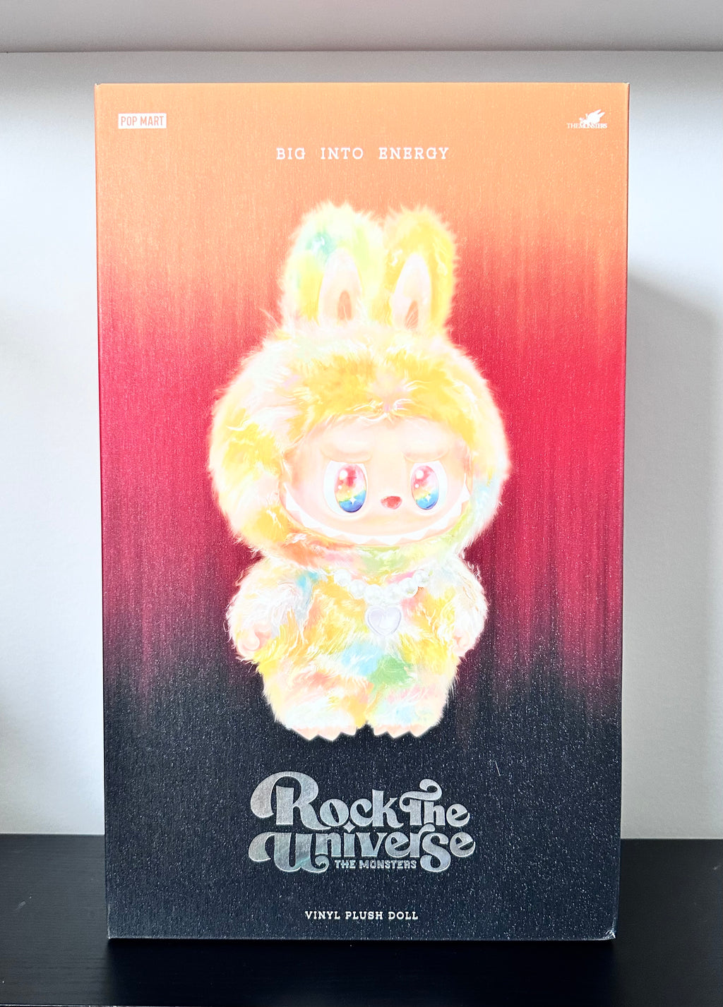 Plush doll packaging with gradient background and text