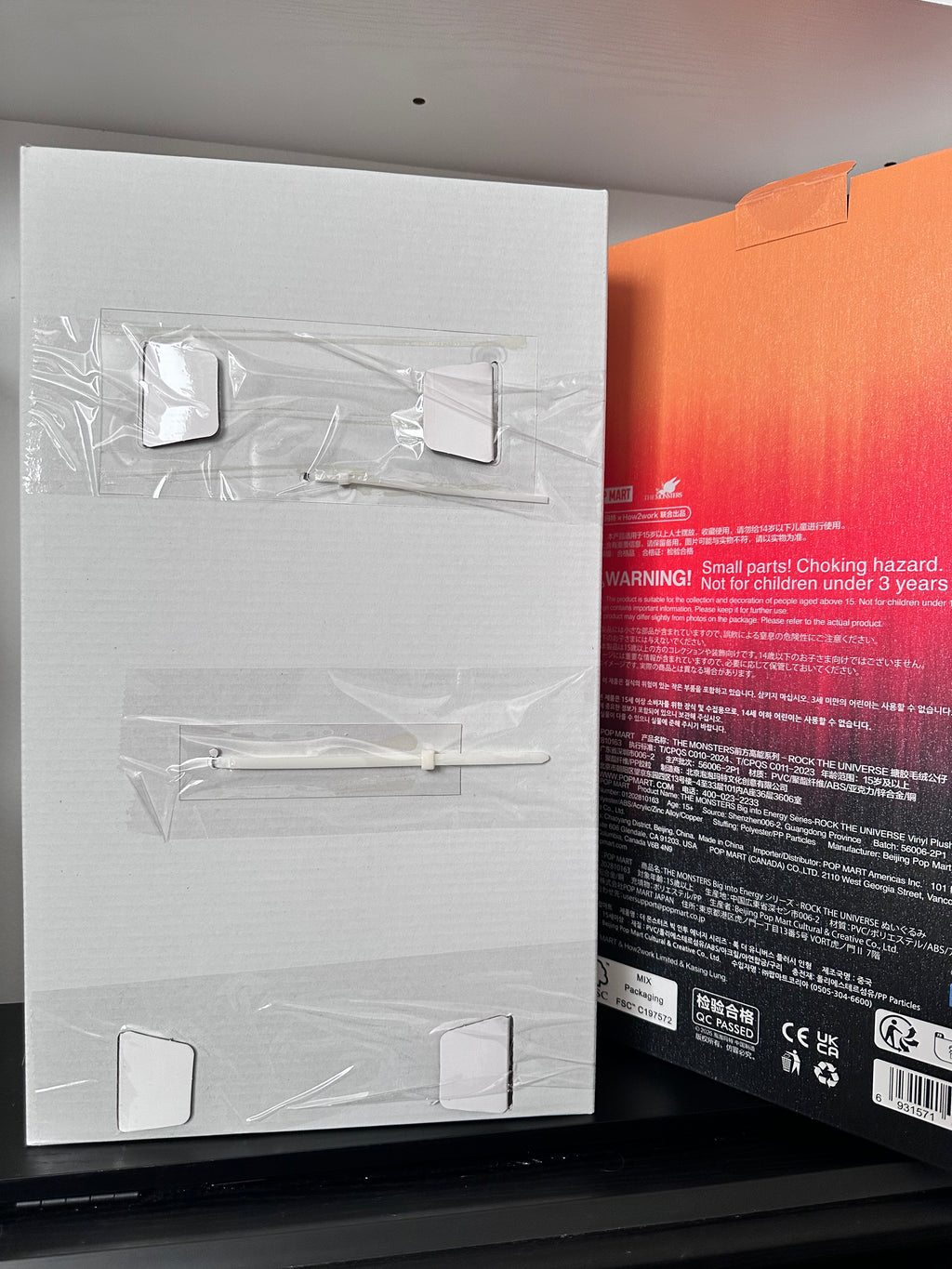 Product packaging with clear plastic covers on a white surface