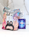 Plush toys and packaging with colorful designs on a white background