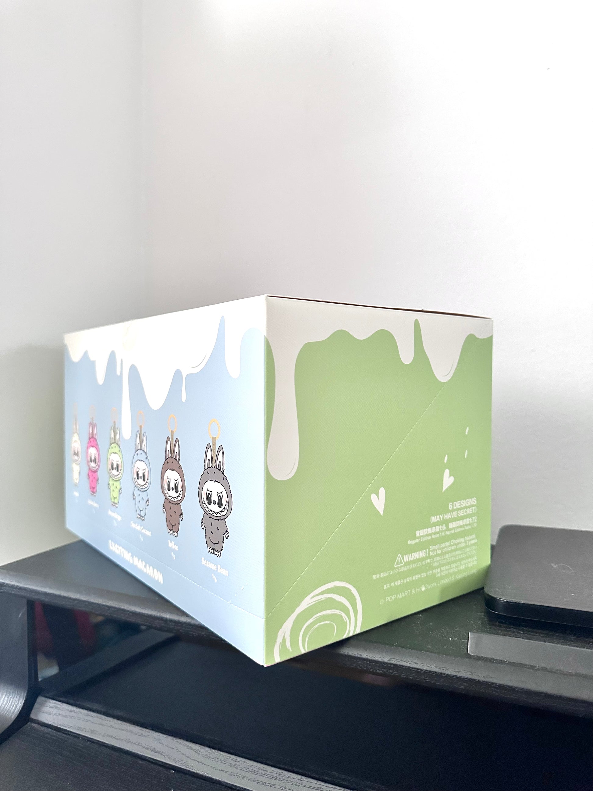Product packaging box with cartoon characters on a desk